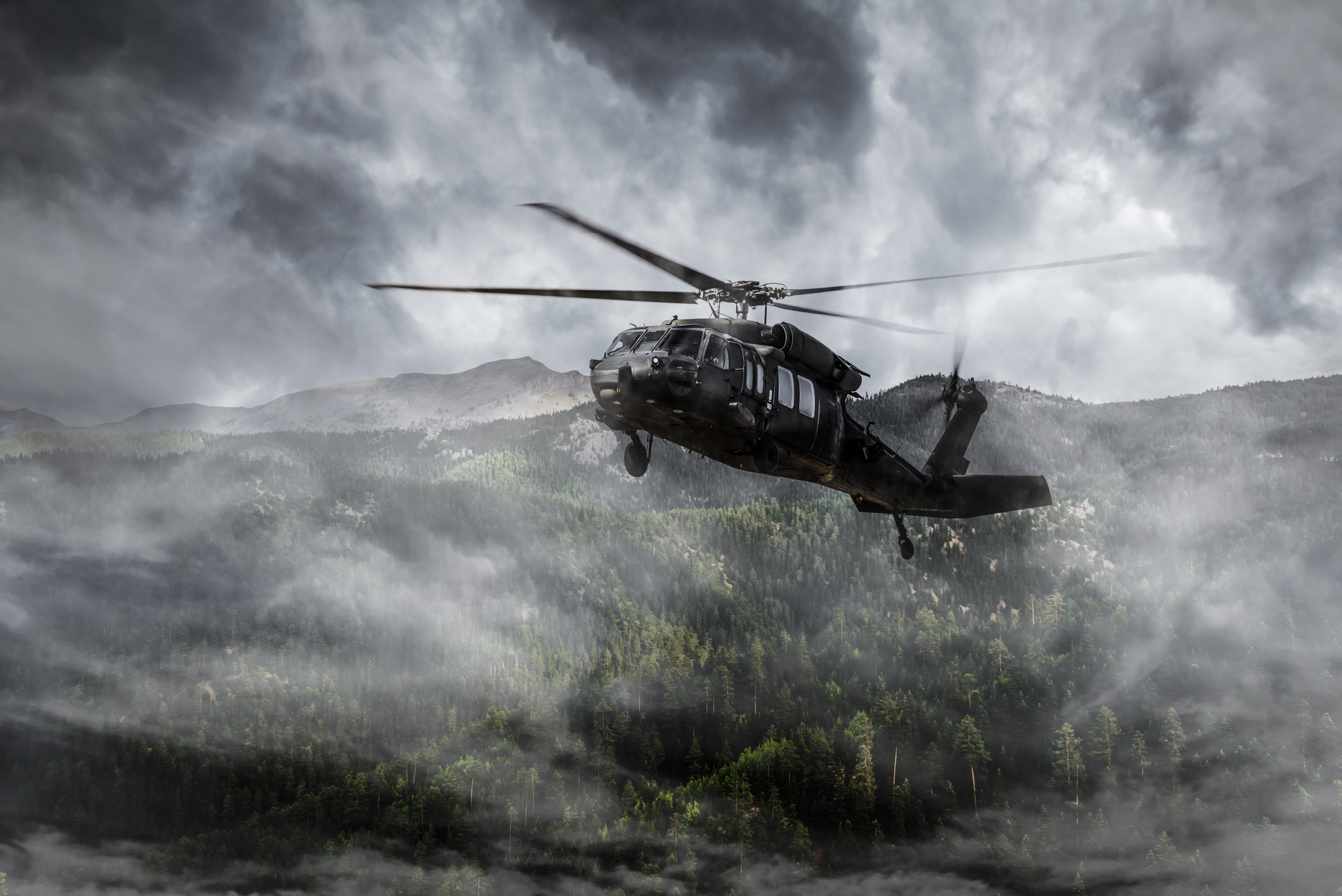 Army Helicopter Flies over Foggy Mountains GettyImages 490823500